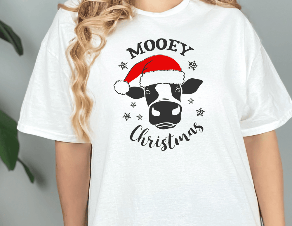 A unisex jersey tee featuring a cow wearing a Santa hat, part of the Mooey Christmas Tee collection. Soft cotton, ribbed knit collars, and Airlume combed cotton ensure a comfortable fit.