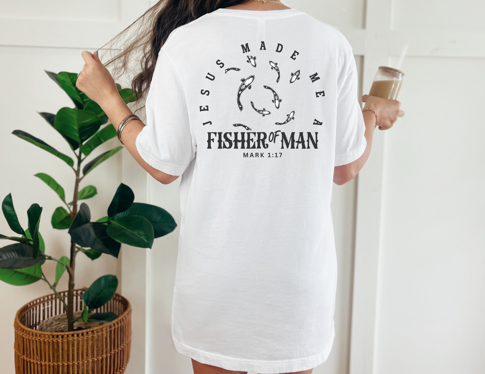 A white shirt featuring a fish design, part of the Fisher of Man Tee collection by Worlds Worst Tees. Unisex heavy cotton tee with ribbed knit collar and durable tape on shoulders.