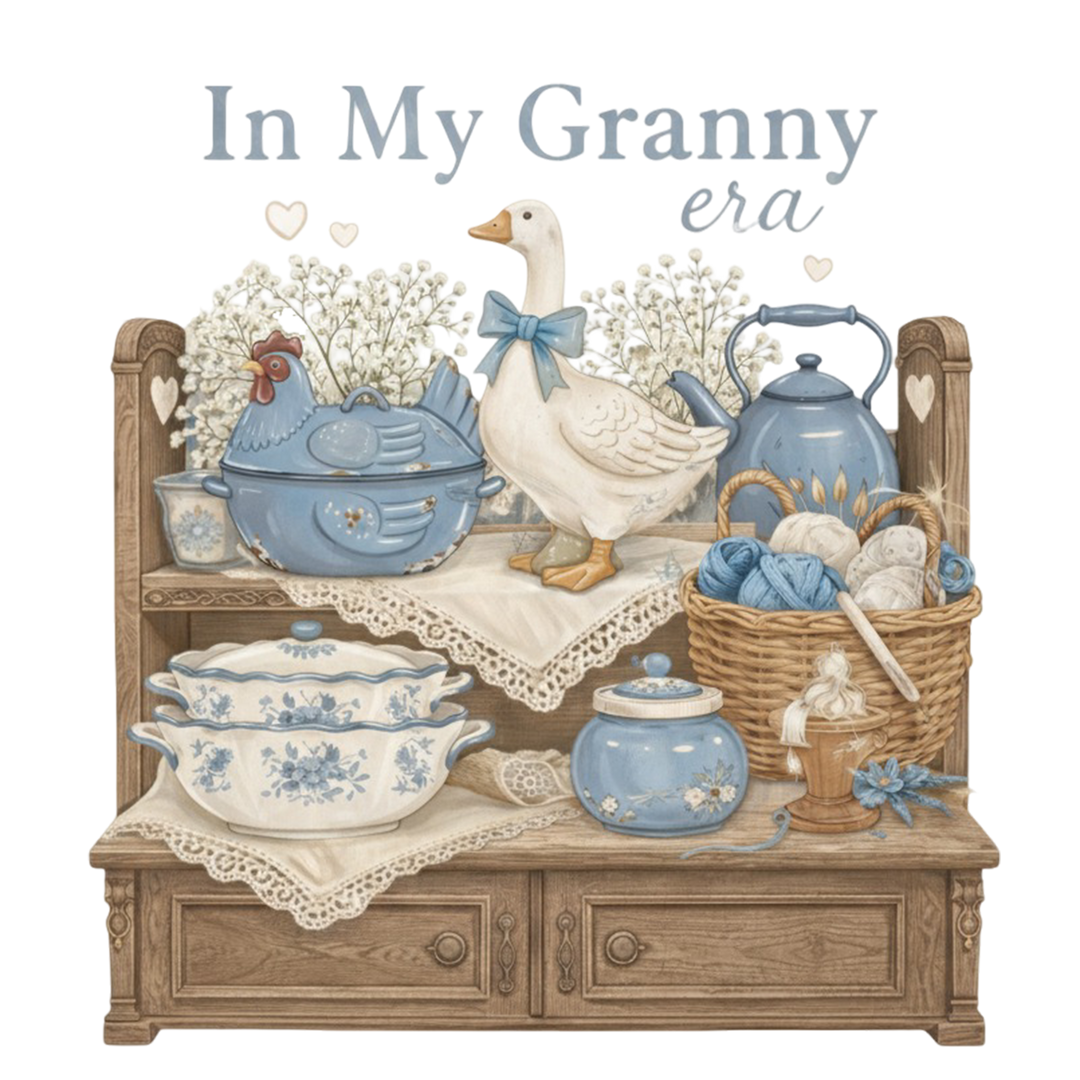 In My Granny Era Crew displayed in a cozy kitchen scene, featuring vintage-inspired elements like a goose figurine, enamelware, and yarn basket, embodying nostalgic comfort.