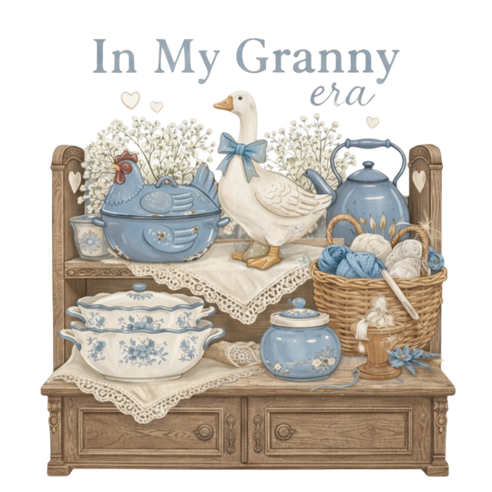 In My Granny Era Crew displayed in a cozy kitchen scene, featuring vintage-inspired elements like a goose figurine, enamelware, and yarn basket, embodying nostalgic comfort.