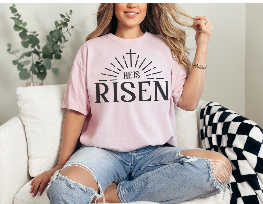 A relaxed fit He is Risen Tee, crafted from 100% ring-spun cotton for ultimate comfort. Garment-dyed with double-needle stitching for durability, this tee features a tubular shape without side-seams.