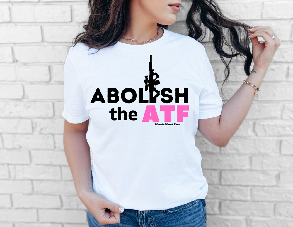 Abolish the ATF Tee featuring a bold graphic design, worn by a woman in casual attire, exemplifying Second Amendment support.
