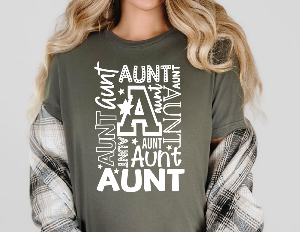 Woman wearing a grey Aunt Tee with white text, showcasing a casual, relaxed fit. Made from 100% ring-spun cotton, ideal for everyday wear.