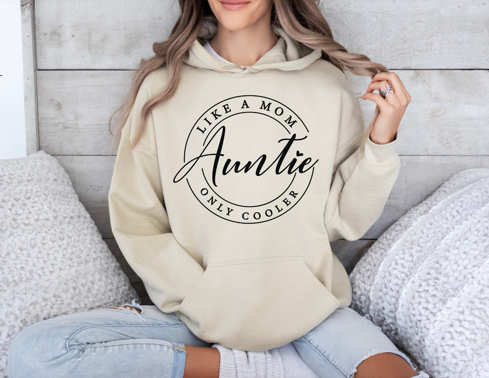 Woman wearing an Auntie Hoodie, sitting casually, showcasing the sweatshirt's relaxed fit and soft blend fabric, ideal for cozy, stylish comfort.