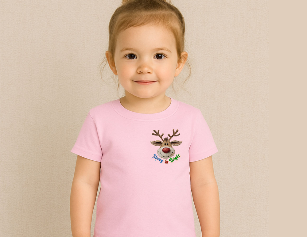 Toddler wearing a Merry and Bright Tee with a cartoon reindeer face and antlers, highlighting the shirt's playful design and festive theme.