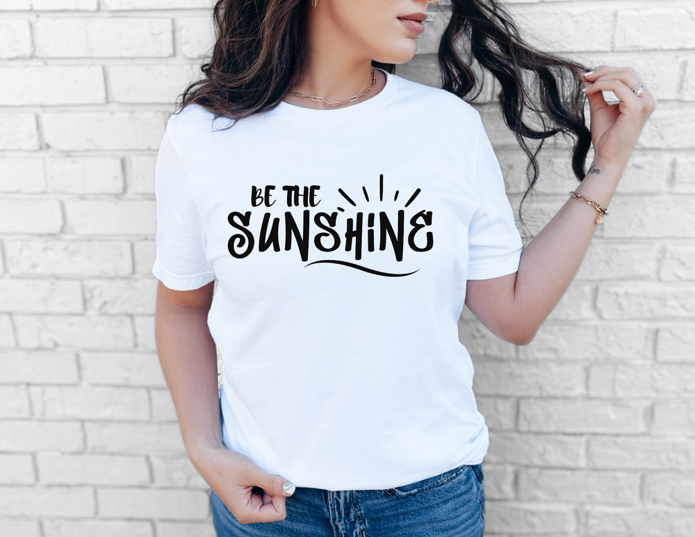 Woman in a white shirt wearing the Be The Sunshine Tee, showcasing its casual fit and soft cotton texture, ideal for everyday wear.