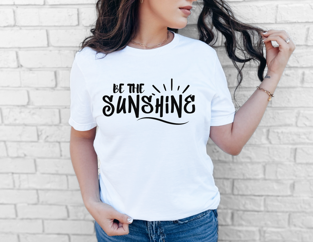 Woman in a white shirt wearing the Be The Sunshine Tee, showcasing its casual fit and soft cotton texture, ideal for everyday wear.