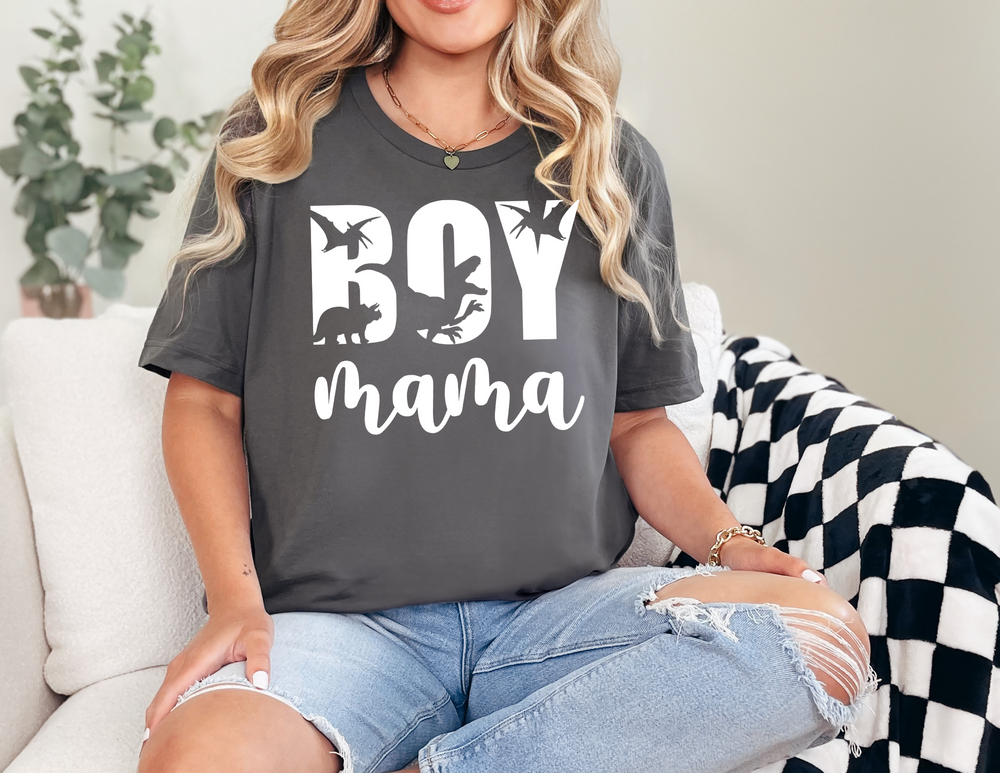 Woman sitting on a couch wearing a Total Boy Mama Tee, a relaxed-fit, garment-dyed t-shirt made of 100% ring-spun cotton, showcasing casual comfort.