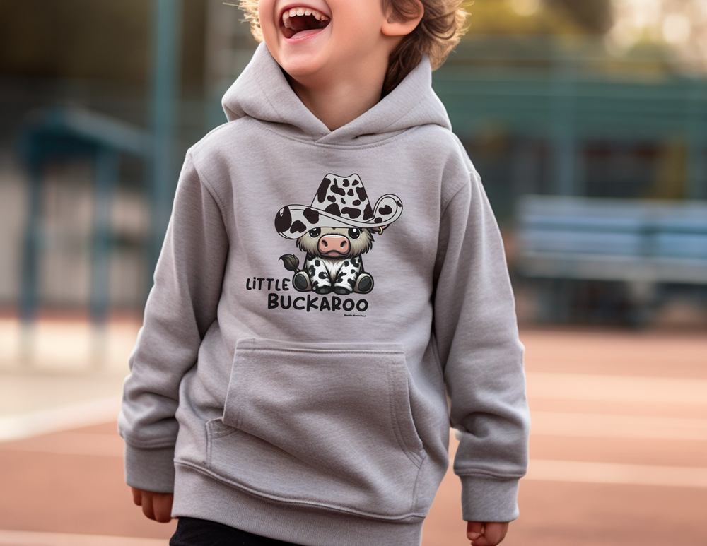 A toddler hoodie featuring a cow in a cowboy hat design, crafted for durability and comfort. Jersey-lined hood, cover-stitched details, and side seam pockets for cozy wear. From Worlds Worst Tees.