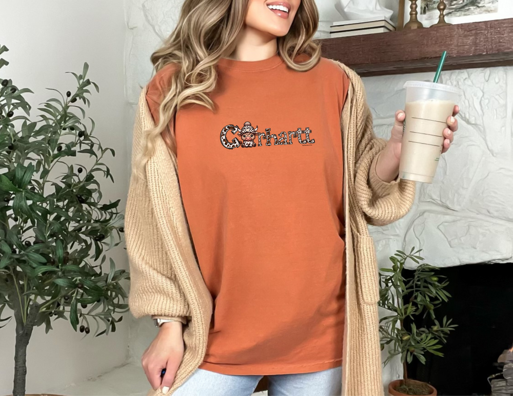 A relaxed fit Cowhartt Cow Tee, crafted from 100% ring-spun cotton. Garment-dyed for extra coziness, featuring double-needle stitching for durability and a seamless design for a tubular shape.