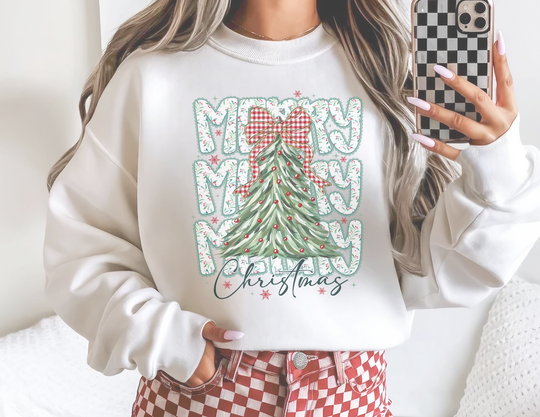 Person wearing Merry Merry Merry Christmas Crew sweatshirt with a stylized tree design, paired with red-and-white checkerboard pants, capturing a trendy holiday outfit in a mirror selfie.