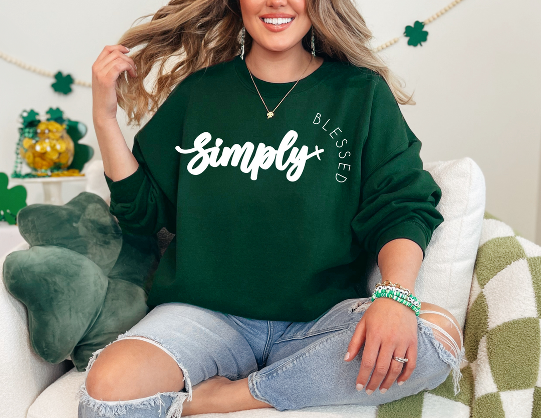 Woman on a couch wearing the Simply Blessed Crew sweatshirt, showcasing a comfortable, unisex design with ribbed knit collar, perfect for casual settings.