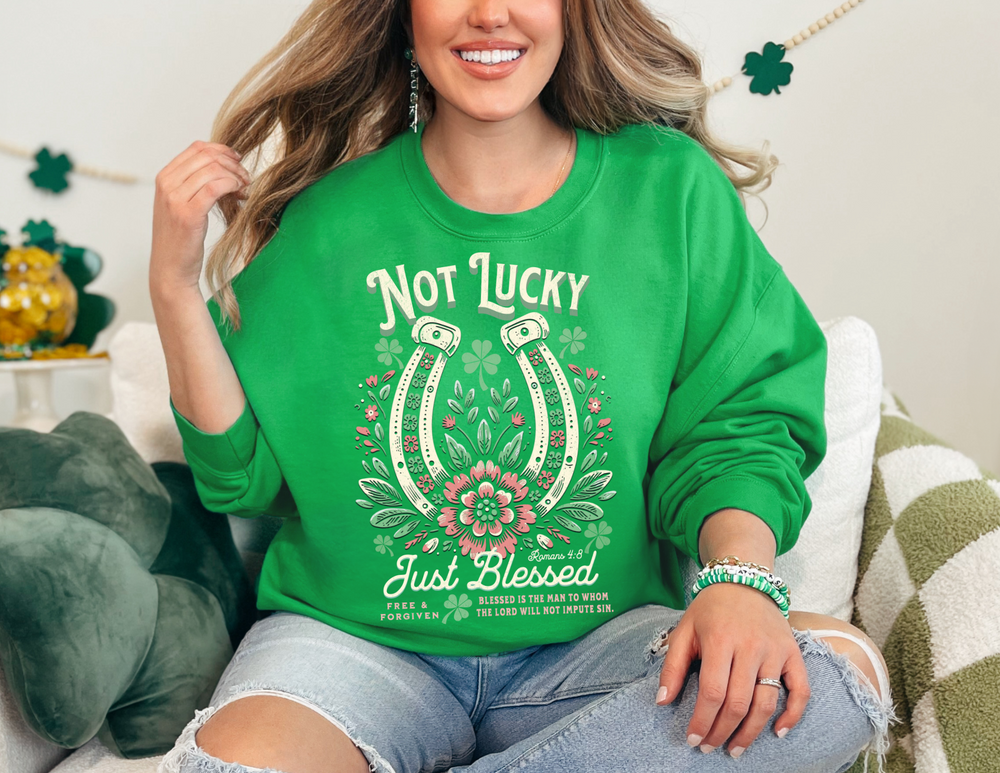 Woman smiling on a couch, wearing the Blessed Crew unisex heavy blend crewneck sweatshirt, showcasing its comfortable fit and stylish design.