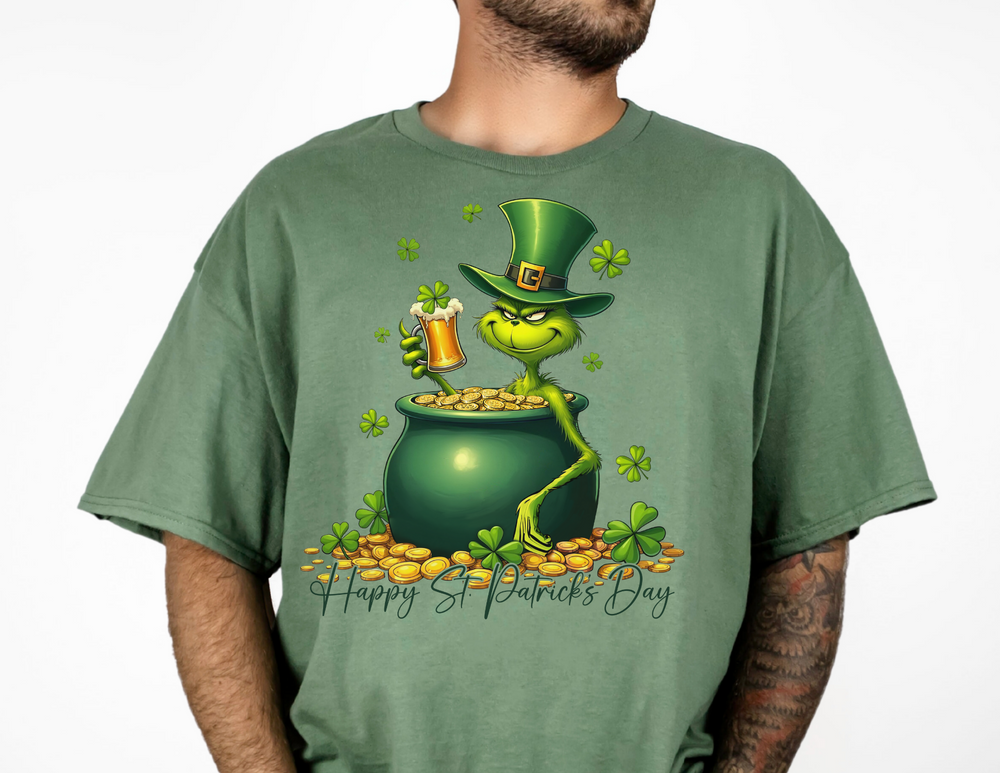 Grinchy St Patrick's Tee features a cartoon frog in a pot of gold on a green shirt, ideal for fans of quirky graphic t-shirts.