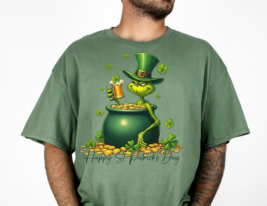 Grinchy St Patrick's Tee features a cartoon frog in a pot of gold on a green shirt, ideal for fans of quirky graphic t-shirts.