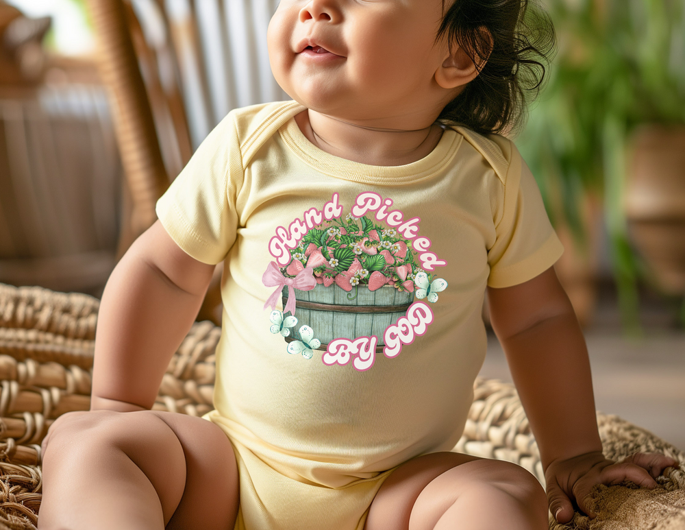 Hand Picked by GOD Onesie: soft, infant rib bodysuit with lap shoulders, crafted from 100% combed ringspun cotton, designed for comfort and easy adjustments.