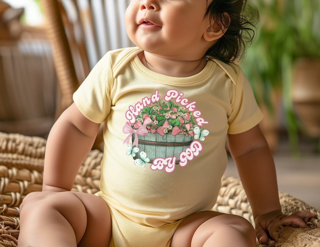 Hand Picked by GOD Onesie: soft, infant rib bodysuit with lap shoulders, crafted from 100% combed ringspun cotton, designed for comfort and easy adjustments.