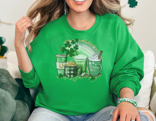 A woman in a green sweatshirt sits on a couch, embodying comfort and style. The Lucky Coffee Crew, a blend crewneck sweatshirt, offers a loose fit, ribbed knit collar, and seamless design for ultimate coziness.