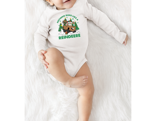 Baby in Reindeere Onesie featuring a festive tow-truck cartoon with Christmas elements, showcasing Faith Family Designs' playful and durable babywear.