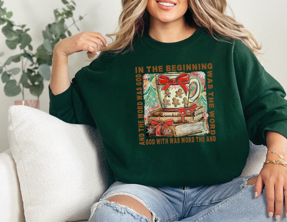 Person wearing In The Beginning Crew sweatshirt with a festive mug and book graphic, echoing Scripture, offering cozy comfort in a classic fit.