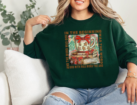 Person wearing In The Beginning Crew sweatshirt with a festive mug and book graphic, echoing Scripture, offering cozy comfort in a classic fit.
