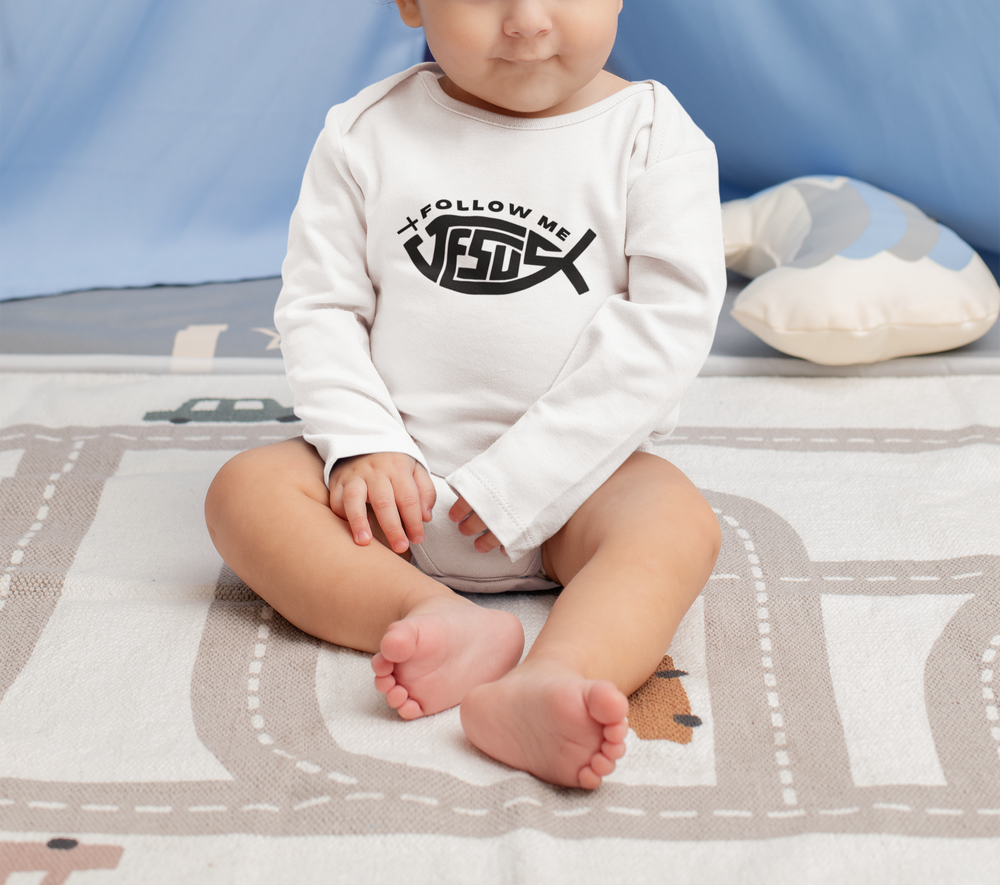 Baby wearing Jesus Follow Me long sleeve onesie sits on a blanket, showcasing its soft, durable fabric and convenient snap closure for easy changing.