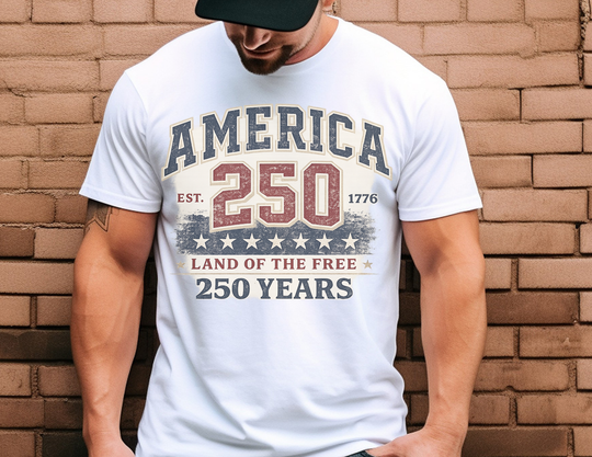 Person wearing the America 250 Years Tee, featuring distressed text and patriotic graphics, celebrating the United States' 250th anniversary.