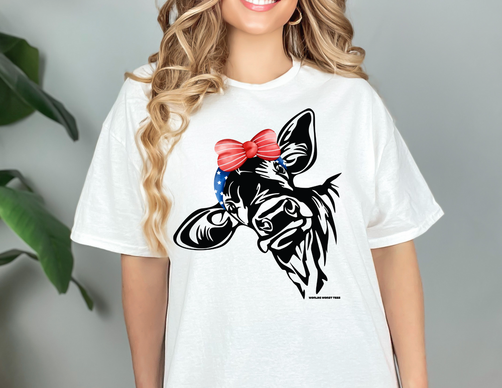 A smiling woman in a Mama Cow Tee, showcasing a classic fit unisex heavy cotton shirt. No side seams, durable tape on shoulders, and ribbed knit collar. Medium weight fabric, 100% cotton.