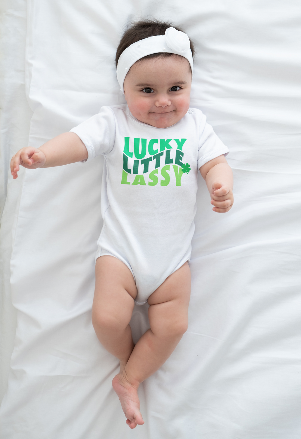 A Lucky Little Lassy Onesie for infants, featuring soft ring-spun cotton fabric. Lap shoulders for easy dressing. Unisex fit, light fabric, tear-away label. Ideal for newborns up to 24M.