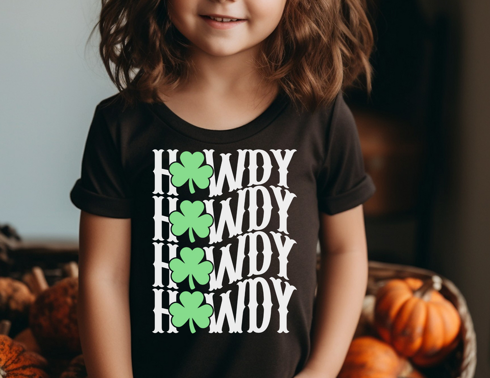 Howdy Lucky Toddler's Tee featuring a child wearing it, standing in front of pumpkins. Perfect for sensitive skin with a durable print, ideal for toddlers.