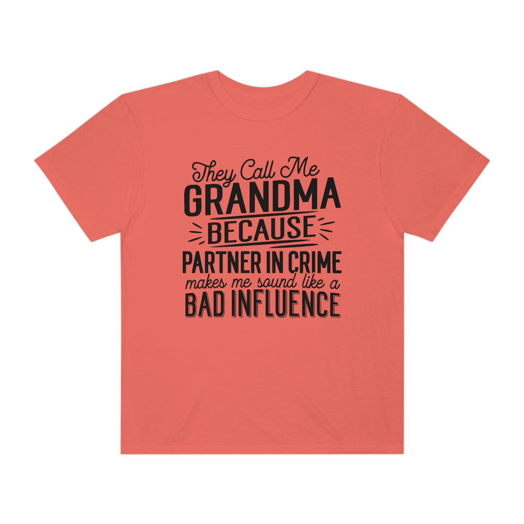 A relaxed fit They Call Me Grandma Tee, featuring black text on a pink background. Made of 100% ring-spun cotton, with double-needle stitching for durability and a tubular shape.
