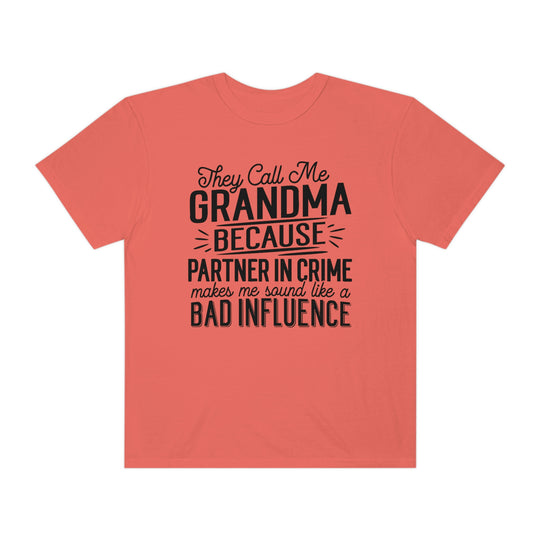 A relaxed fit They Call Me Grandma Tee, featuring black text on a pink background. Made of 100% ring-spun cotton, with double-needle stitching for durability and a tubular shape.