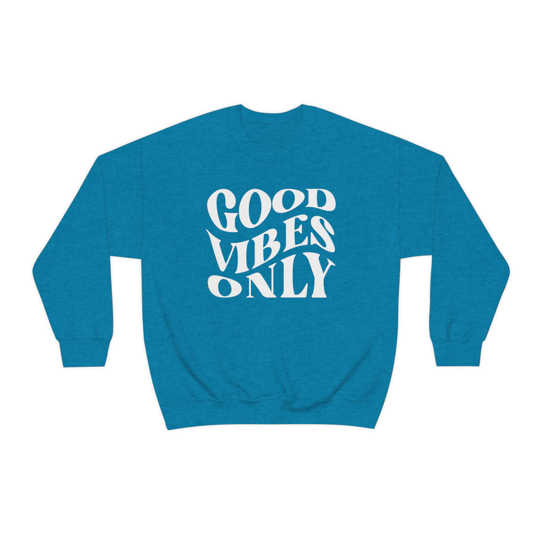 A unisex heavy blend crewneck sweatshirt featuring Good Vibes Only text. Comfortable, loose fit with ribbed knit collar. Made of 50% cotton, 50% polyester. Ideal for everyday wear.