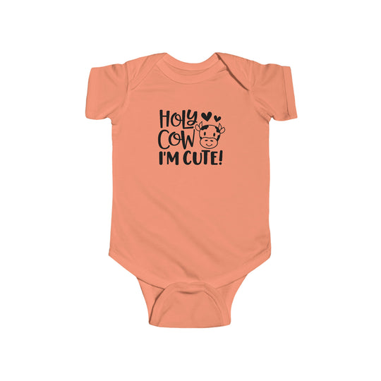 A baby bodysuit featuring a cute cow design, made of soft 100% cotton fabric with ribbed bindings for durability. Plastic snaps for easy changing access. Title: Holy Cow I'm Cute Onesie.