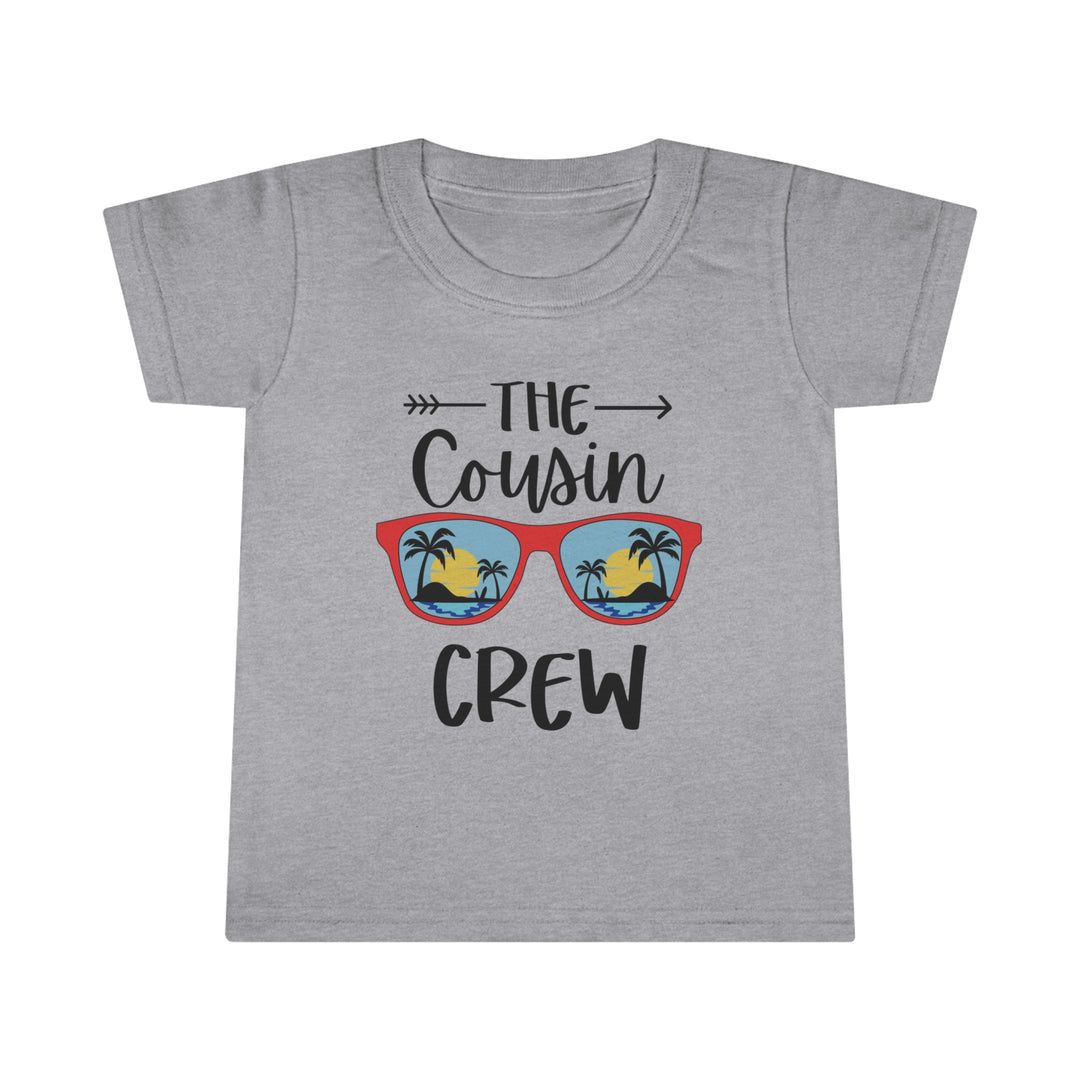 A personalized toddler tee featuring a graphic design of a beach with palm trees. Classic fit for comfort, high stitch density for smooth printing, and durable double-needle collar, sleeve, and bottom hems. Made of 100% Ringspun cotton.