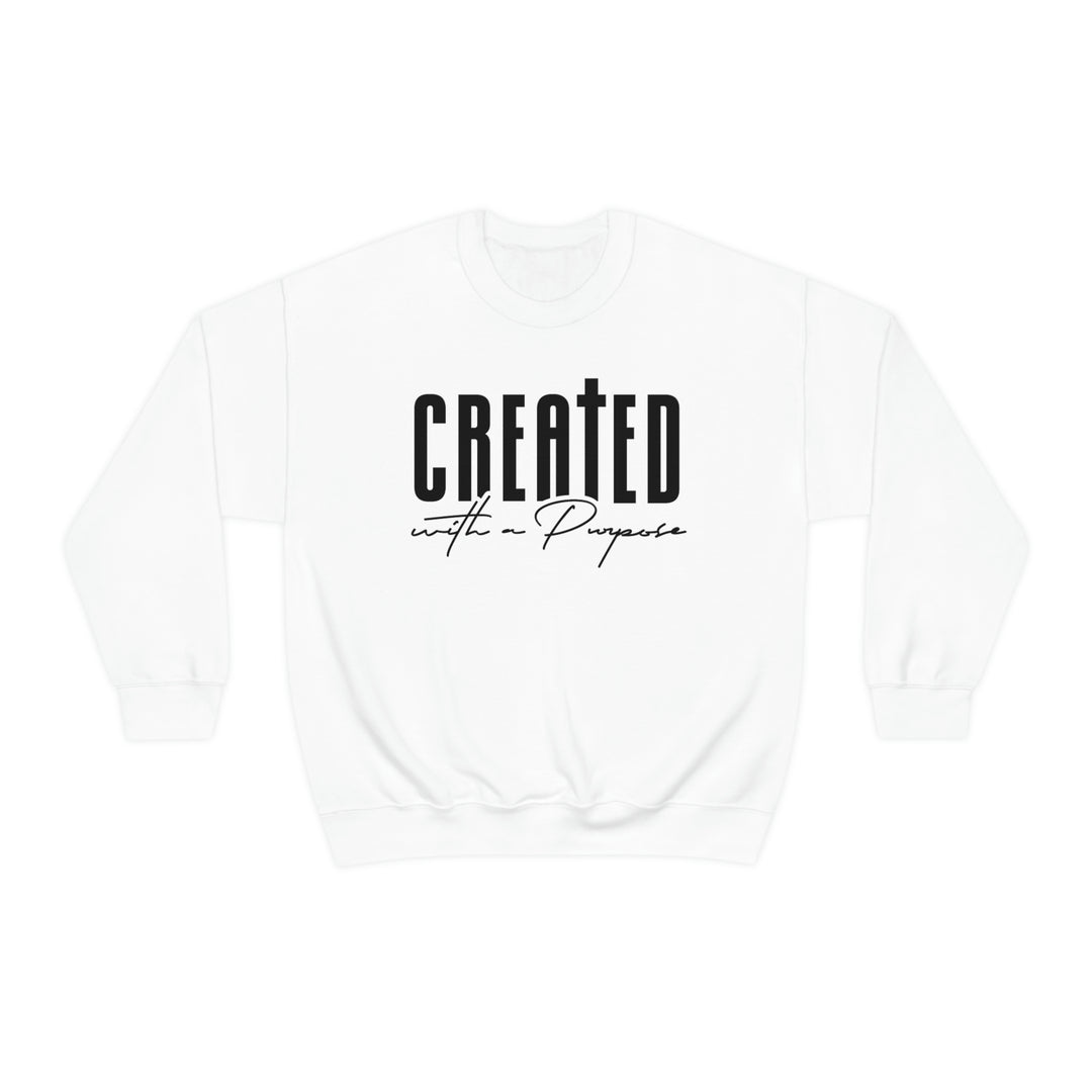 A white crewneck sweatshirt with black text, ideal for any situation. Made from 50% cotton and 50% polyester, featuring a ribbed knit collar and a loose fit. Created With A Purpose Crewneck.