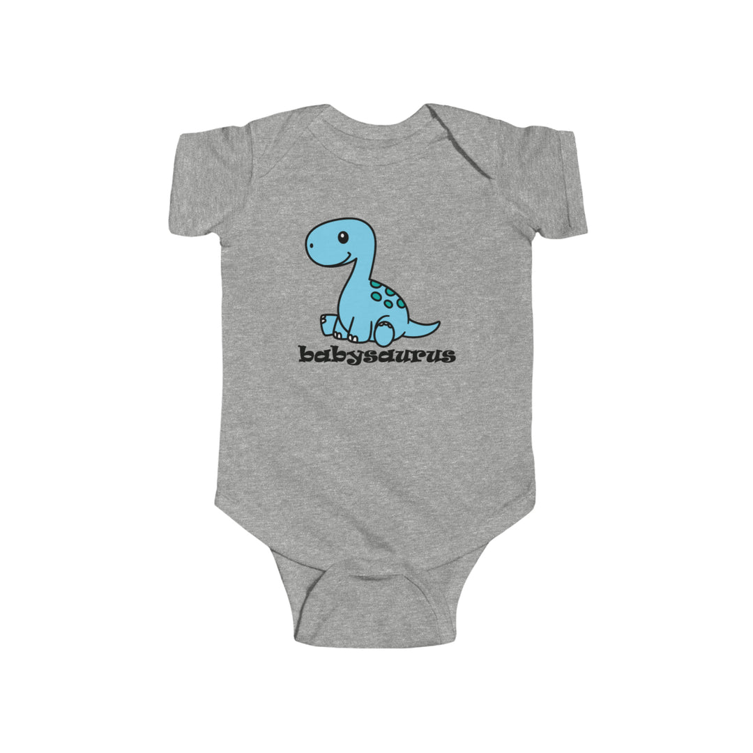 A durable and soft Babysaurus Onesie for infants, featuring a grey bodysuit with a blue cartoon dinosaur. Made of 100% cotton, with ribbed knitting for durability and plastic snaps for easy changing access. Dimensions vary by size.