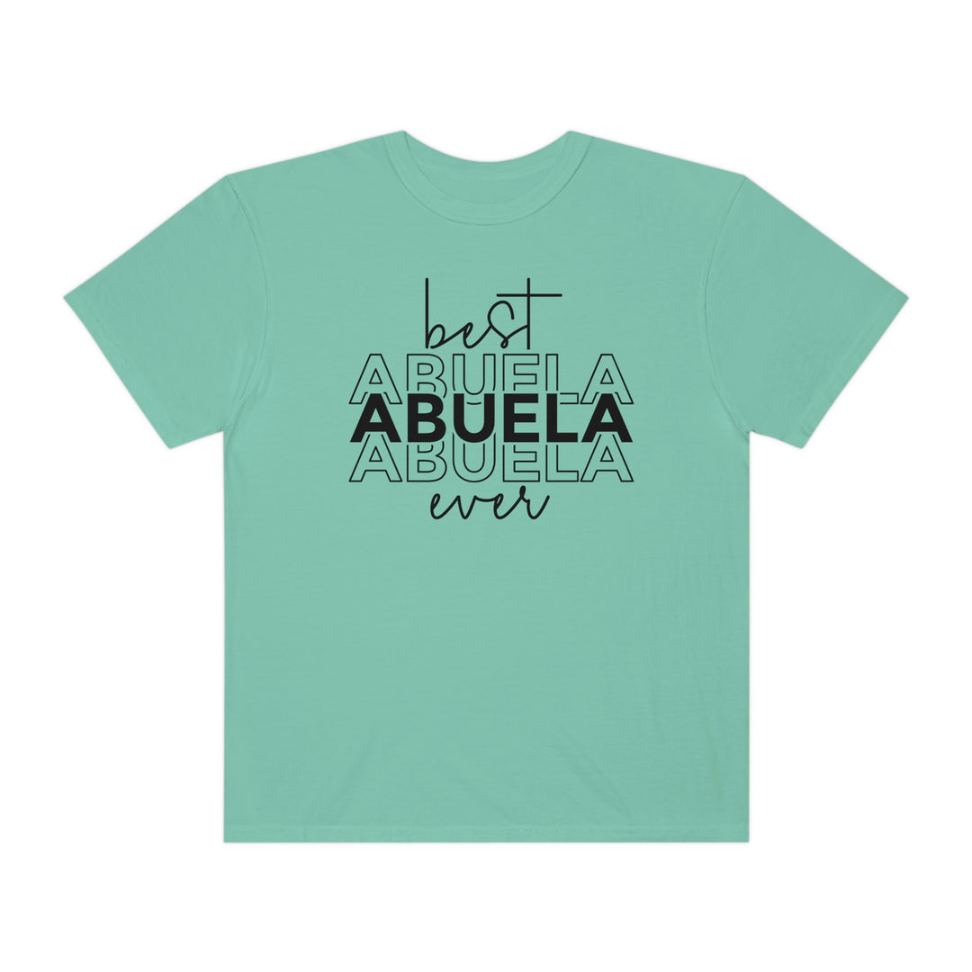 A relaxed-fit Best Abuela Ever Tee, crafted from 100% ring-spun cotton. Garment-dyed for extra coziness, featuring double-needle stitching for durability and a seamless design for a tubular shape.