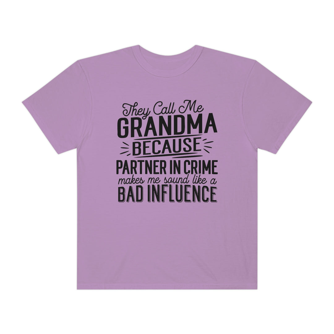 Relaxed fit They Call Me Grandma Tee, a purple shirt with black text. 100% ring-spun cotton, garment-dyed for coziness. Durable double-needle stitching, tubular shape. Ideal for daily wear.