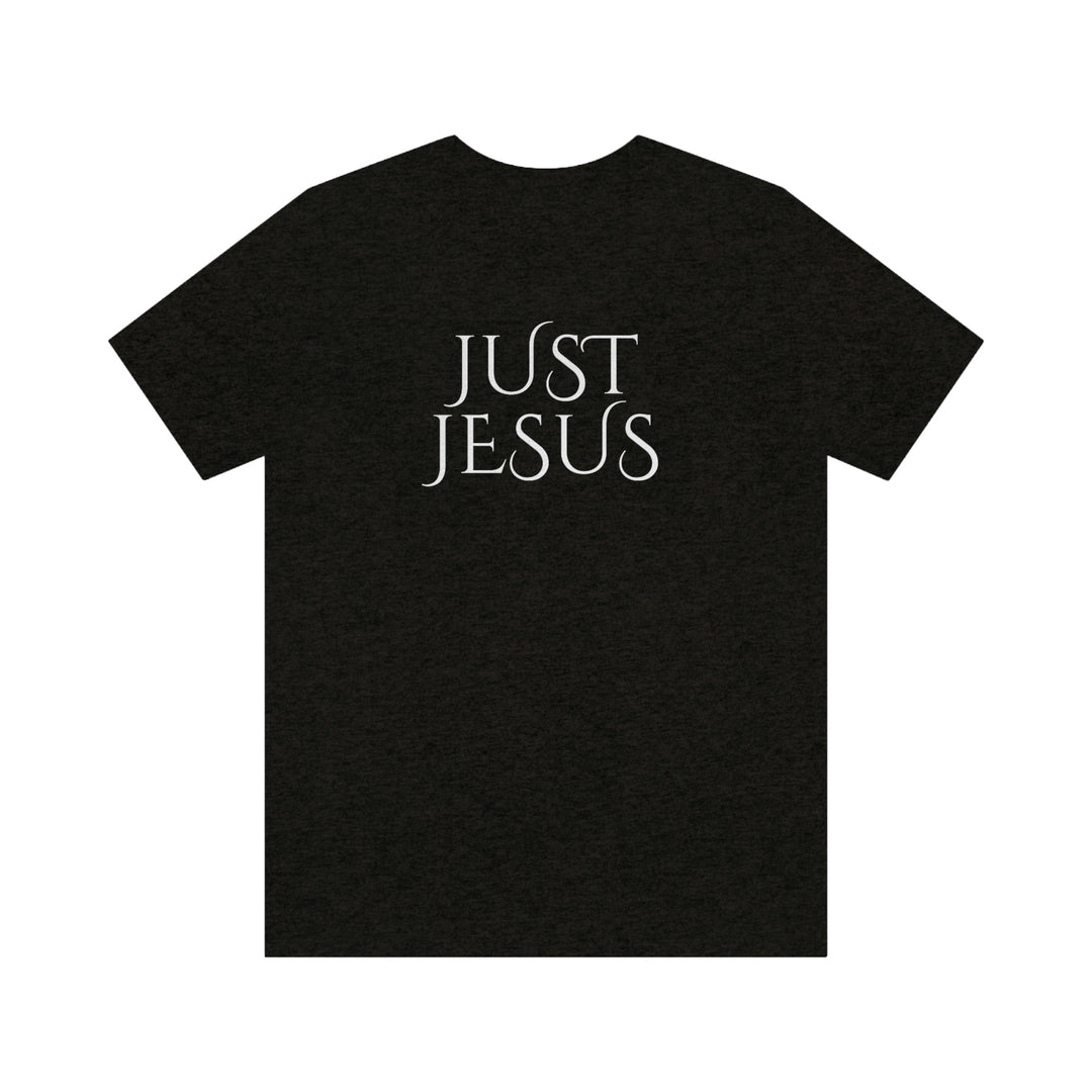 A beloved Just Jesus Tee in black, featuring white text. Unisex jersey tee with ribbed knit collar, Airlume combed cotton, and retail fit. Sizes XS to 3XL. Characteristics: soft fabric, quality print, and durable seams.