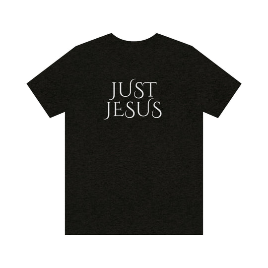 A beloved Just Jesus Tee in black, featuring white text. Unisex jersey tee with ribbed knit collar, Airlume combed cotton, and retail fit. Sizes XS to 3XL. Characteristics: soft fabric, quality print, and durable seams.
