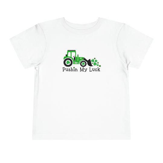 Pushin My Luck Toddler Tee featuring a white t-shirt with a tractor and clovers design. Made of 100% Airlume combed cotton, light fabric, perfect for toddlers. From Worlds Worst Tees.
