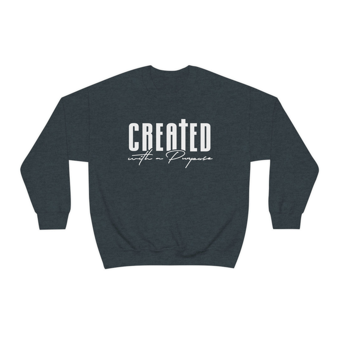 A unisex heavy blend crewneck sweatshirt featuring Created With A Purpose design. Made of 50% cotton and 50% polyester, with ribbed knit collar and no itchy side seams. Medium-heavy fabric, loose fit, and sewn-in label.