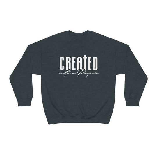 A unisex heavy blend crewneck sweatshirt featuring Created With A Purpose design. Made of 50% cotton and 50% polyester, with ribbed knit collar and no itchy side seams. Medium-heavy fabric, loose fit, and sewn-in label.