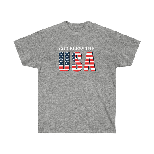 Unisex God Bless The USA Dudes Tee, a classic cotton shirt with patriotic red, white, and blue text. Features include shoulder taping, no side seams, ribbed collar, sustainably sourced materials.