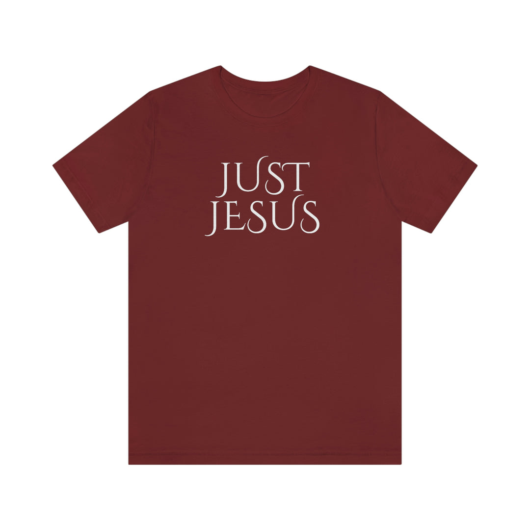 A beloved Just Jesus Tee in red with white text. Unisex jersey tee with ribbed knit collar, shoulder taping, and side seams for lasting shape. Made of 100% Airlume combed cotton.