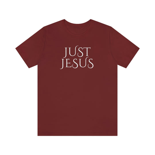 A beloved Just Jesus Tee in red with white text. Unisex jersey tee with ribbed knit collar, shoulder taping, and side seams for lasting shape. Made of 100% Airlume combed cotton.