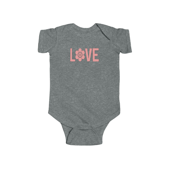 A grey baby bodysuit with pink text and a cute design, ideal for infants. Made of soft 100% cotton fabric with ribbed knitting for durability. Features plastic snaps for easy changing. From Worlds Worst Tees.