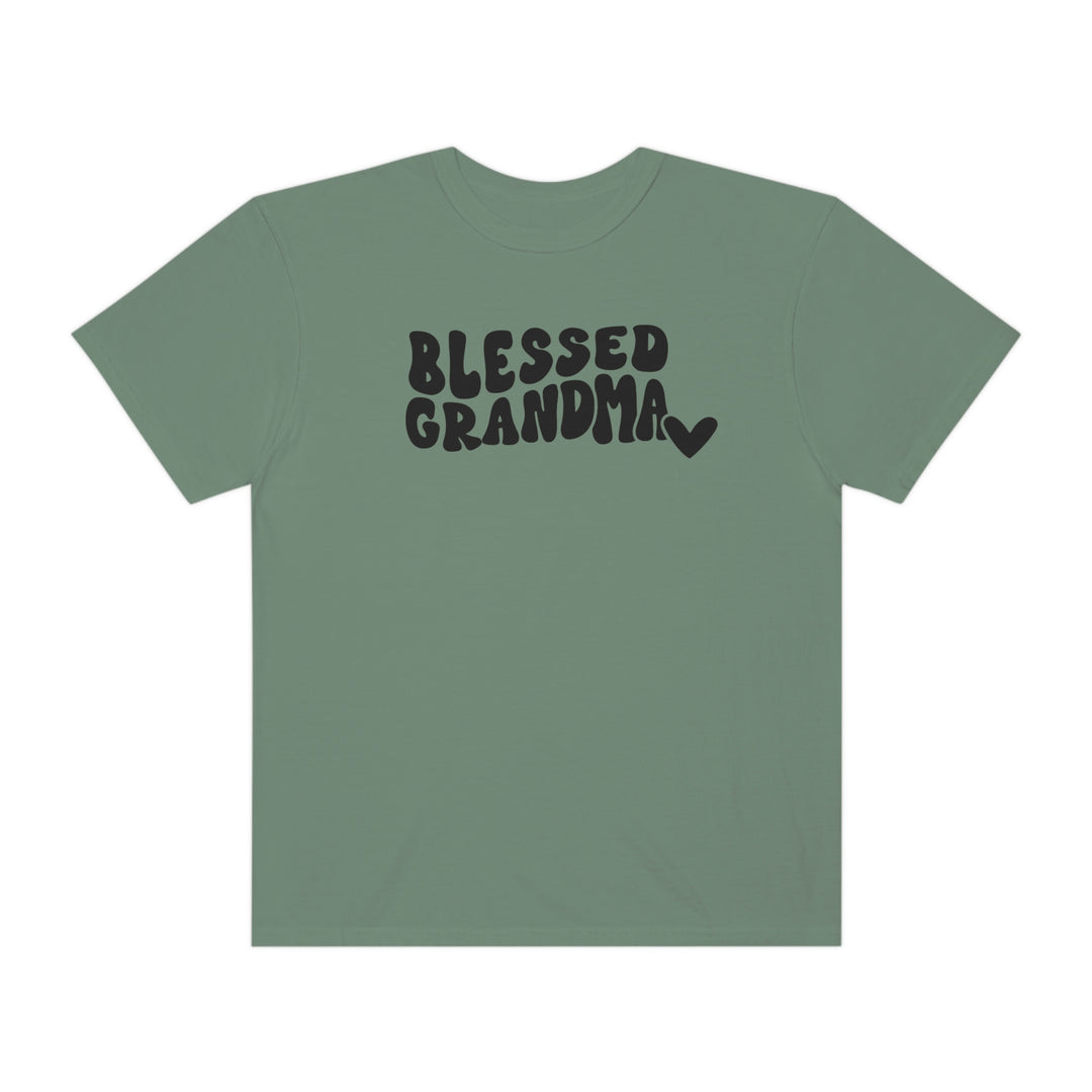A Blessed Grandma Tee, a garment-dyed t-shirt in green with black text. Made of 100% ring-spun cotton, featuring a relaxed fit for daily comfort. Durable double-needle stitching, no side-seams for shape retention.