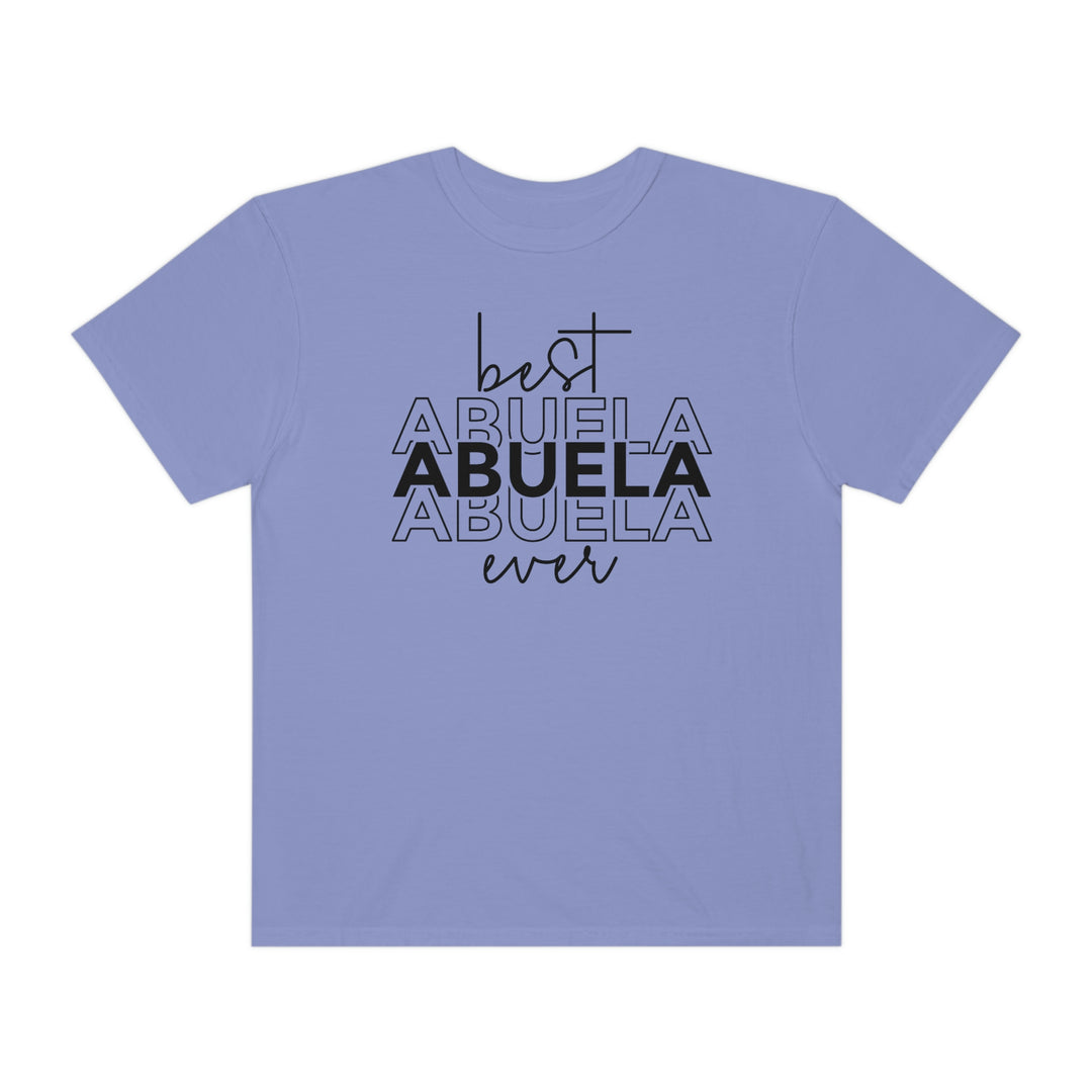 A ring-spun cotton Best Abuela Ever Tee in purple with black text. Garment-dyed for extra coziness, featuring a relaxed fit, double-needle stitching, and no side-seams for durability and shape retention.